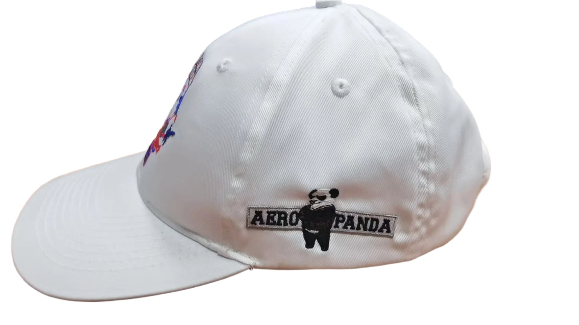 White cap with 'Aero Panda' logo on a wooden surface